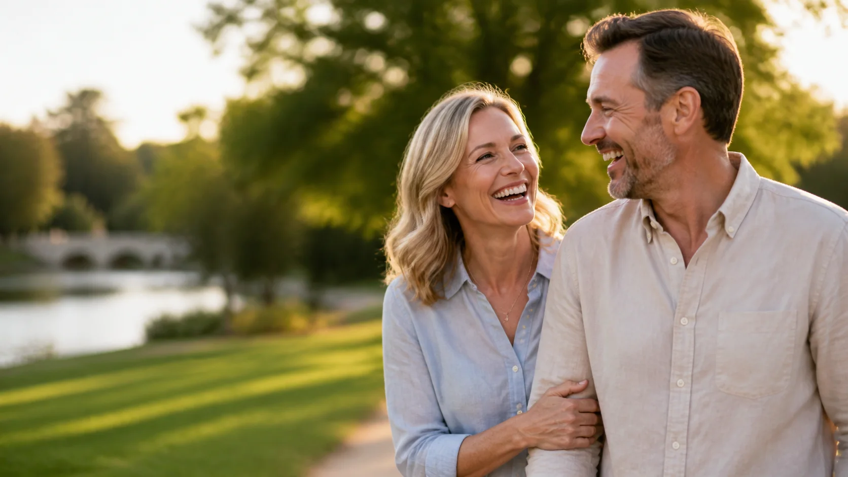 Active couple in their fifties laughing together in a park