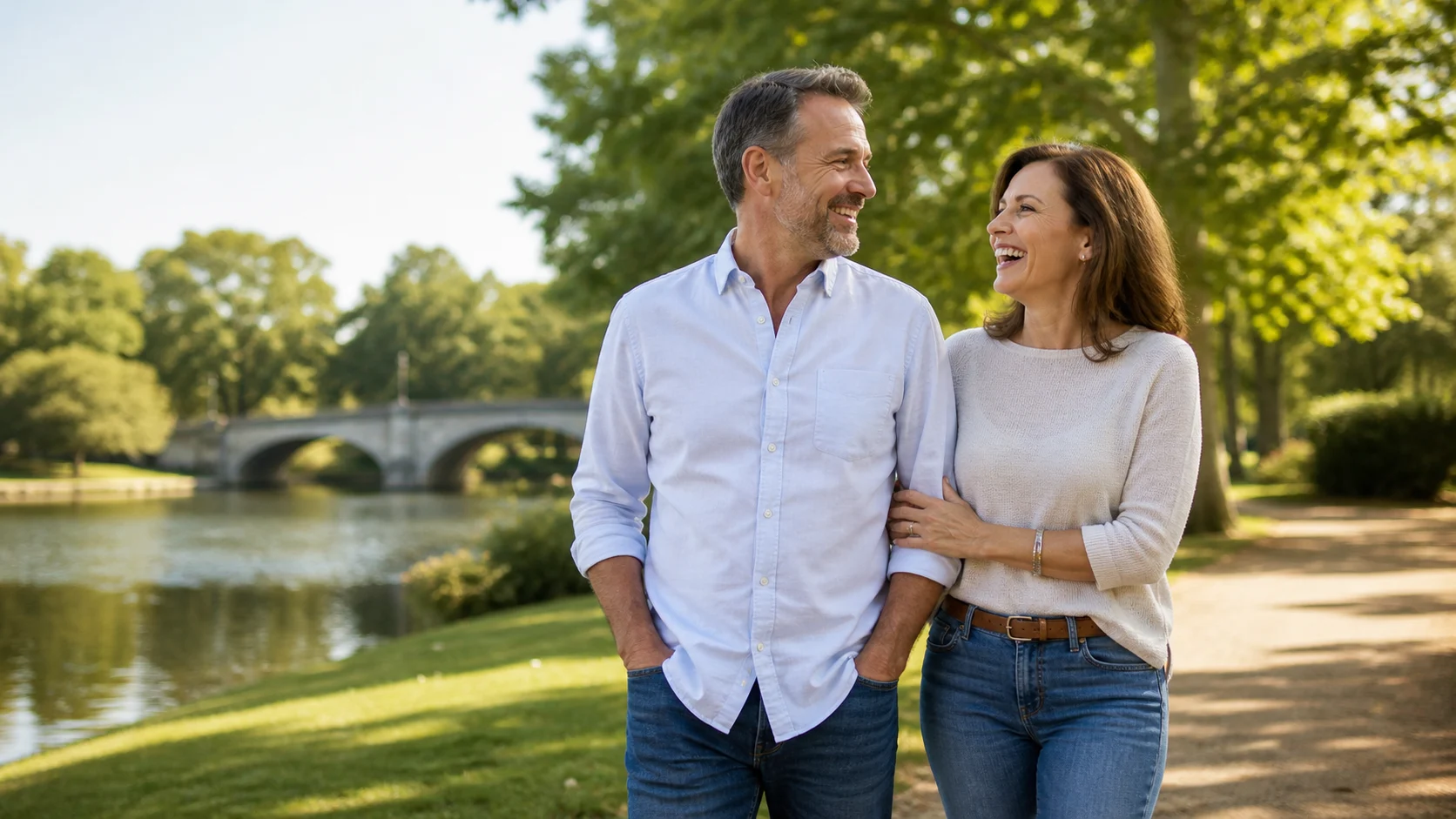 Couple in their fifties laughing together in a park